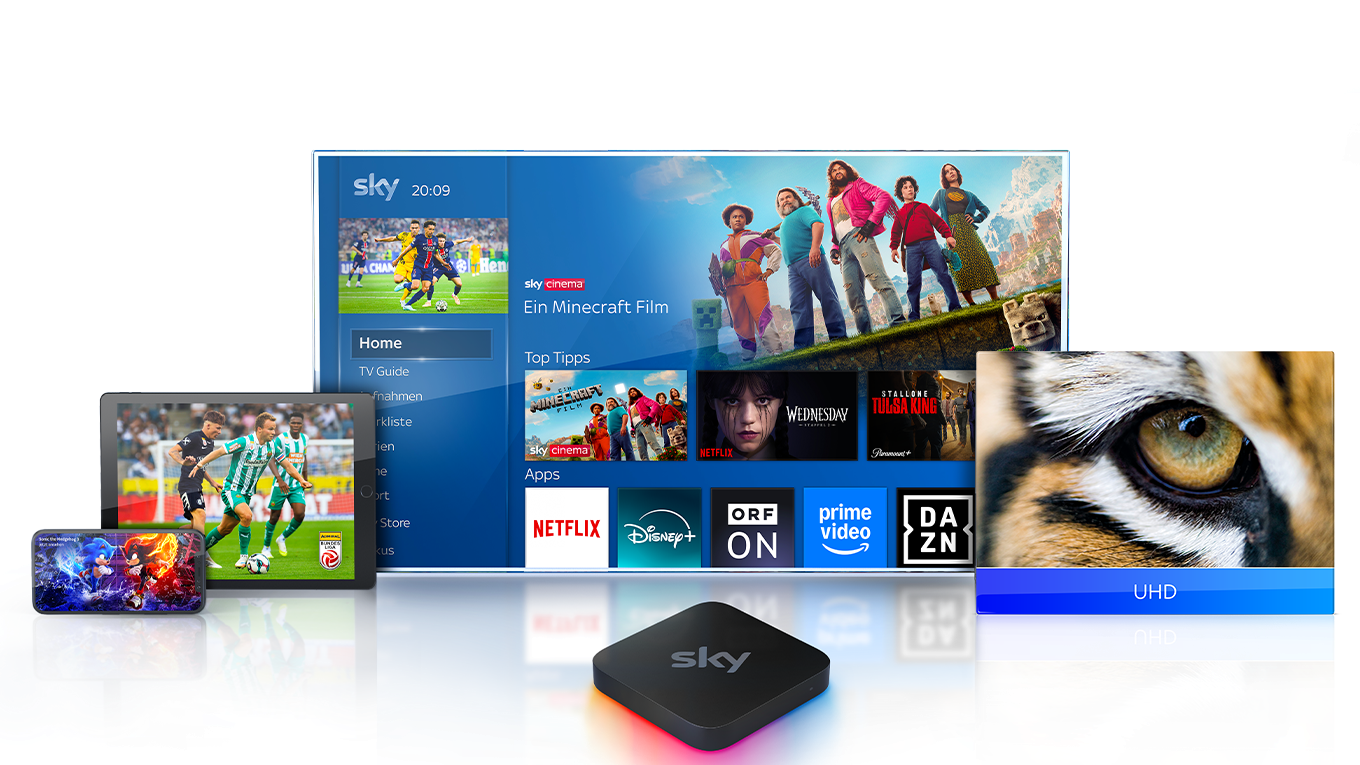 Sky Stream Box vor einem Fernseher, der das Sky Stream UI zeigt, versetzt dahinter Fernseher, Tablet und Handy, die Inhalte von Sky zeigen.