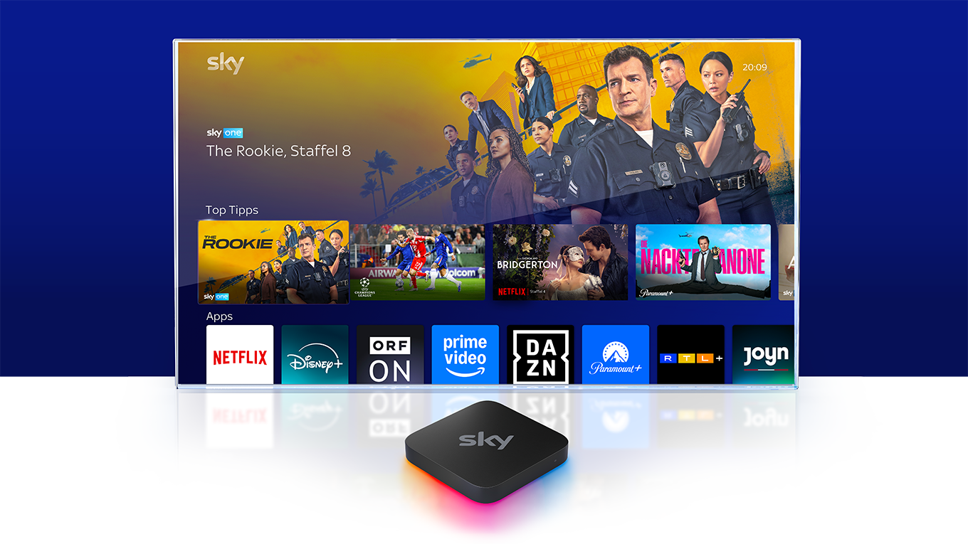 Sky Stream Box vor einem Fernseher, auf dem das Sky Stream UI zu sehen ist.